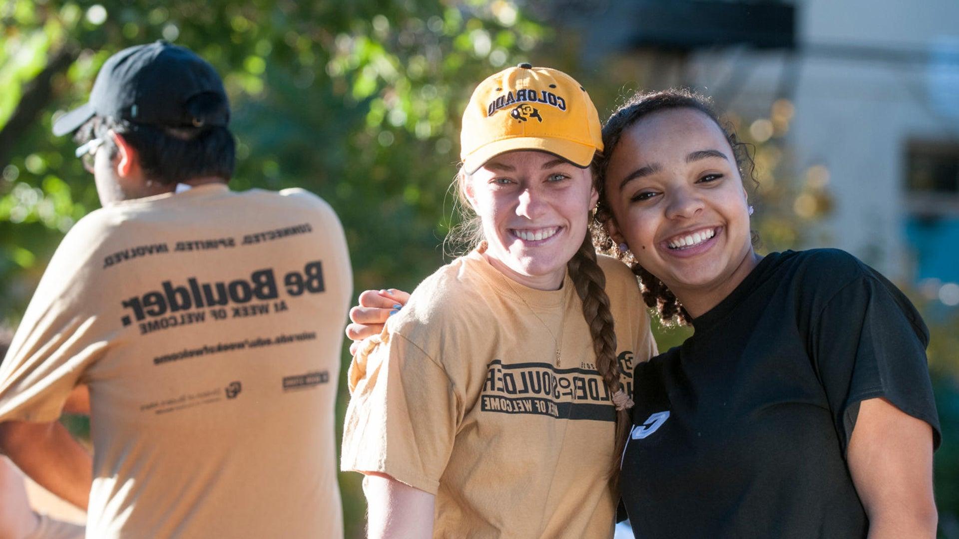 Two CU Boulder alumni hugging at a volunteer event